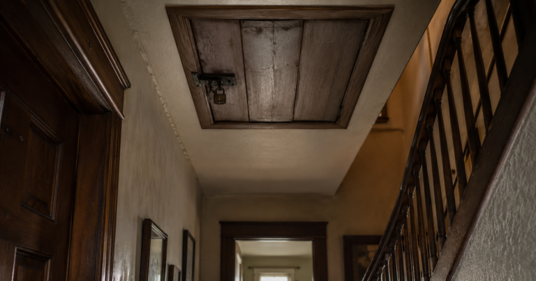 Locked attic door in an old hallway inside a quiet family home.